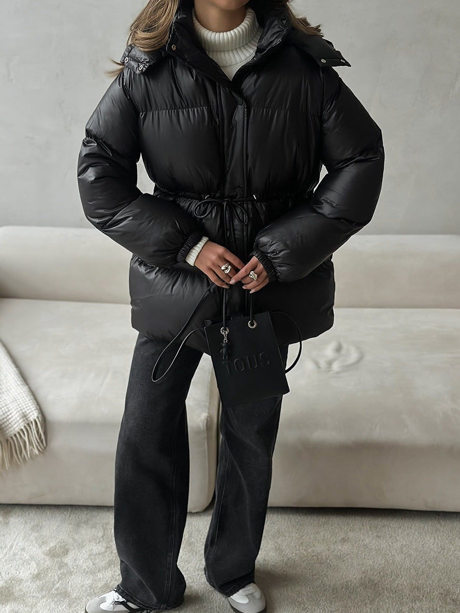 Hooded Puffer Jacket with Drawstring Waist in Black — front view on model