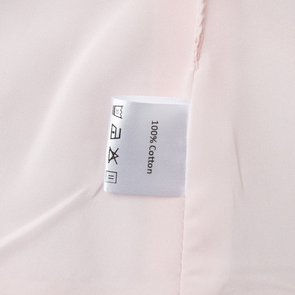 Cotton Peplum Vest & Bubble Mini Skirt Set in Soft Pink — close-up of the 100% cotton label