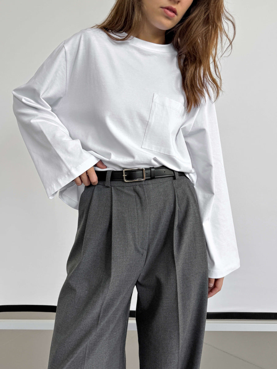 Relaxed Cotton Long-Sleeve Pocket Tee in White — tucked into trousers on model
