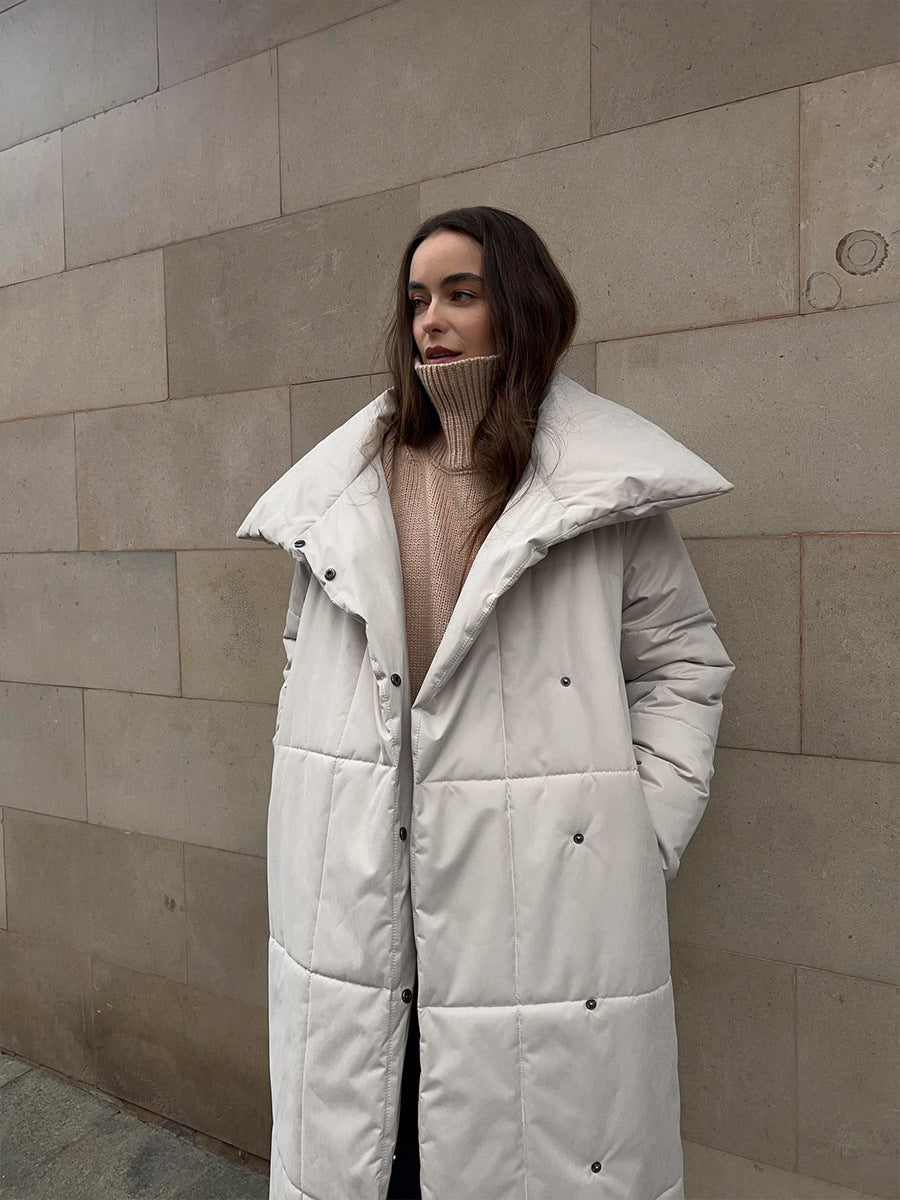 Long Belted Puffer Coat with Oversized Collar in Cream — on model with the collar open