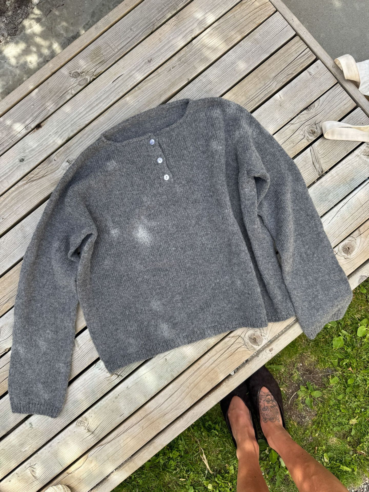 Relaxed Henley Sweater with Button Placket in Charcoal Gray — laid flat, front view