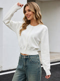 Cropped Crew-Neck Button Cardigan in Ivory — front view on model with jeans