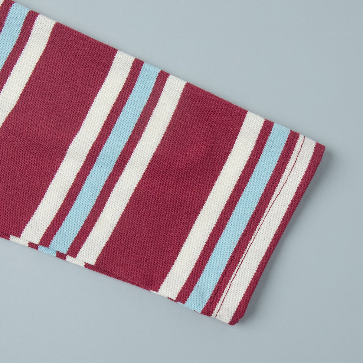 Relaxed Striped Long Sleeve Polo Shirt in Red Stripe — close-up of the sleeve cuff
