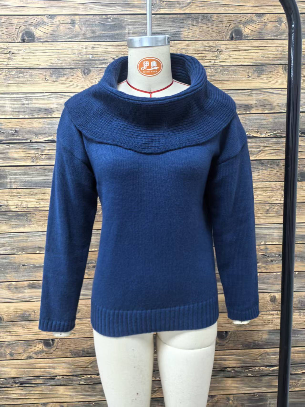 Oversized Cowl-Neck Knit Sweater in Navy — front view on a dress form