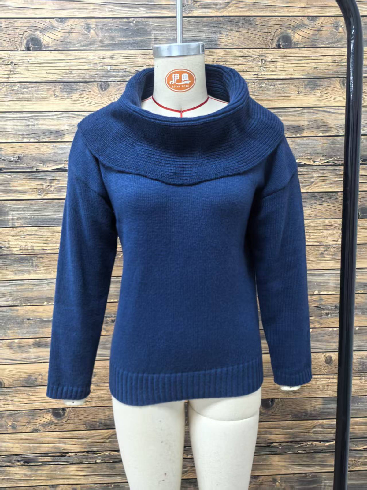 Oversized Cowl-Neck Knit Sweater in Navy — front view on a dress form
