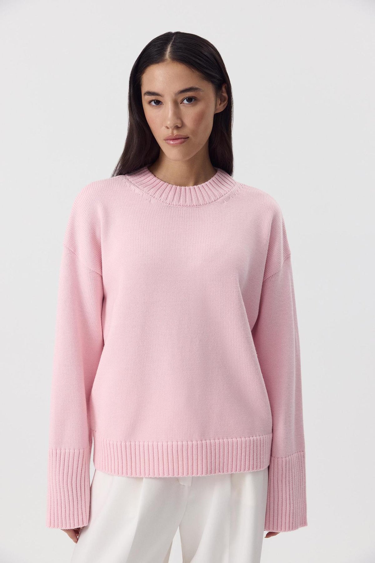 Relaxed Cotton Crew Neck Sweater with Ribbed Cuffs in Ballet Pink — front view on model