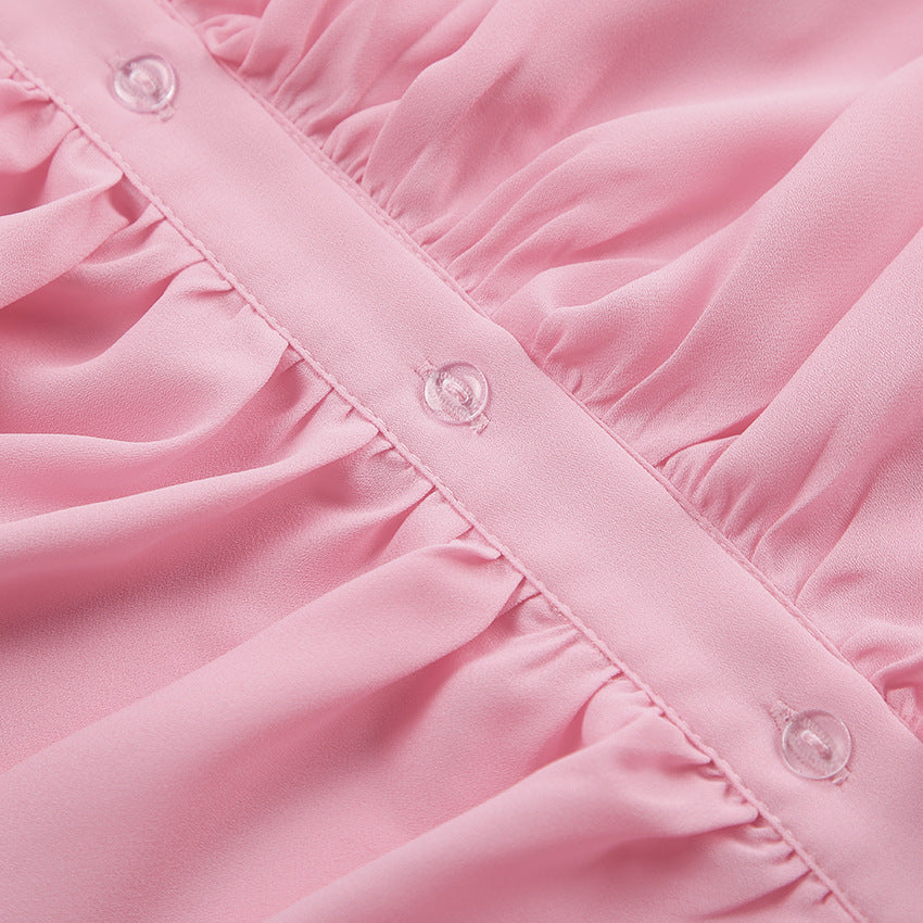 Cascading Ruffle Blouse with Bell Sleeves in Pink — close-up of the ruffled button placket