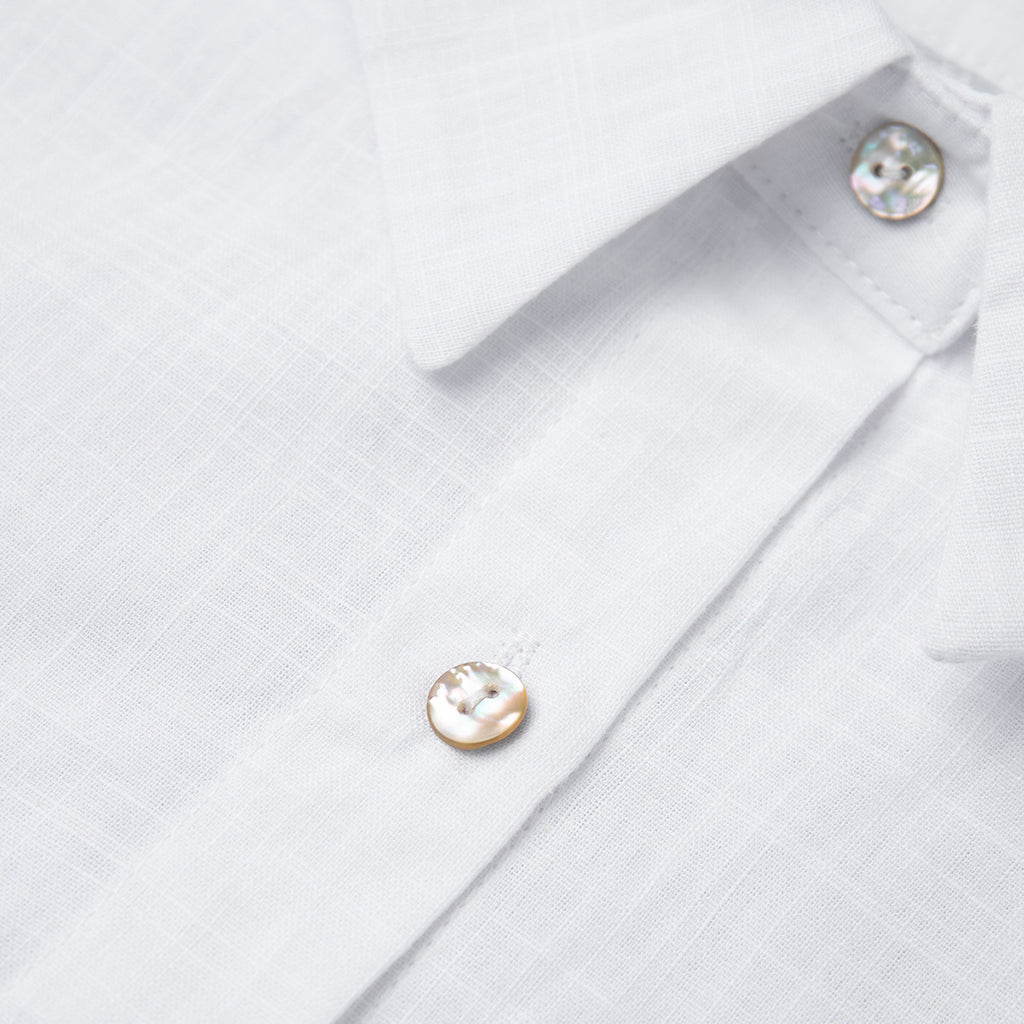 Relaxed Cotton Button-Down Shirt in White — close-up of the gold-tone buttons