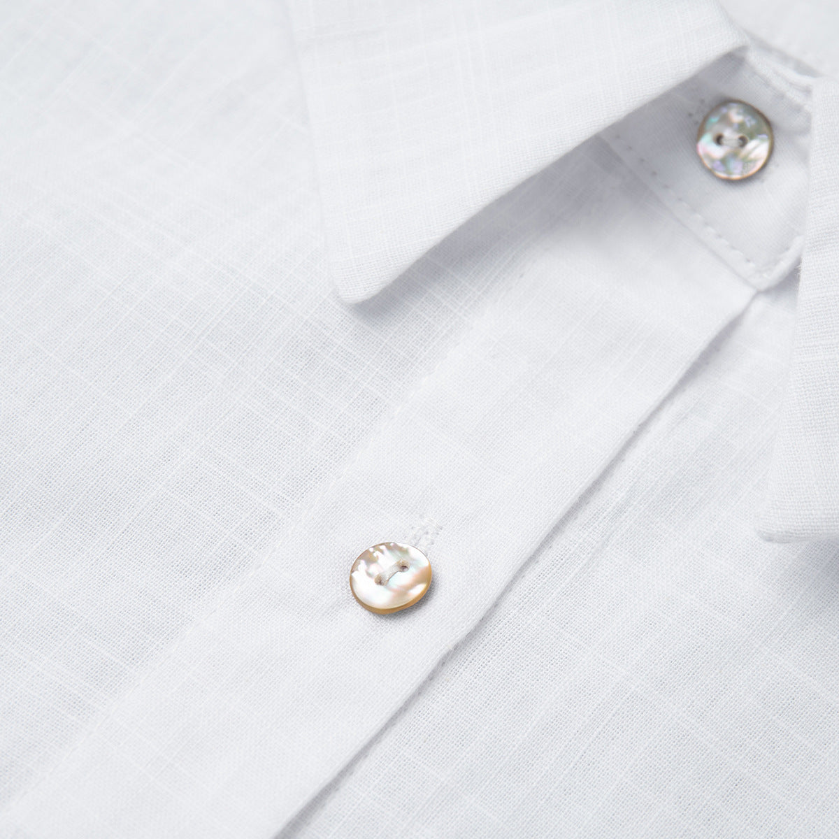 Relaxed Cotton Button-Down Shirt in White — close-up of the gold-tone buttons
