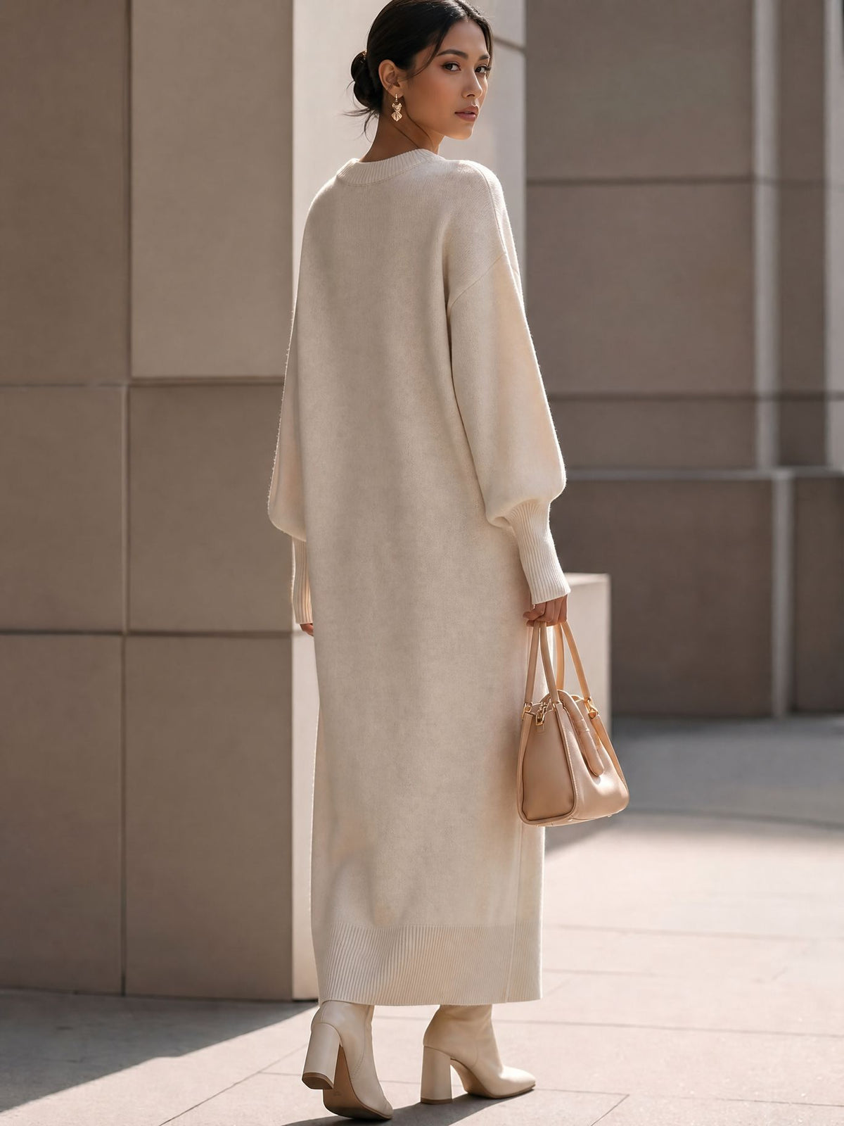 Balloon-Sleeve Knit Maxi Sweater Dress in Ivory — back view on model with ribbed hem