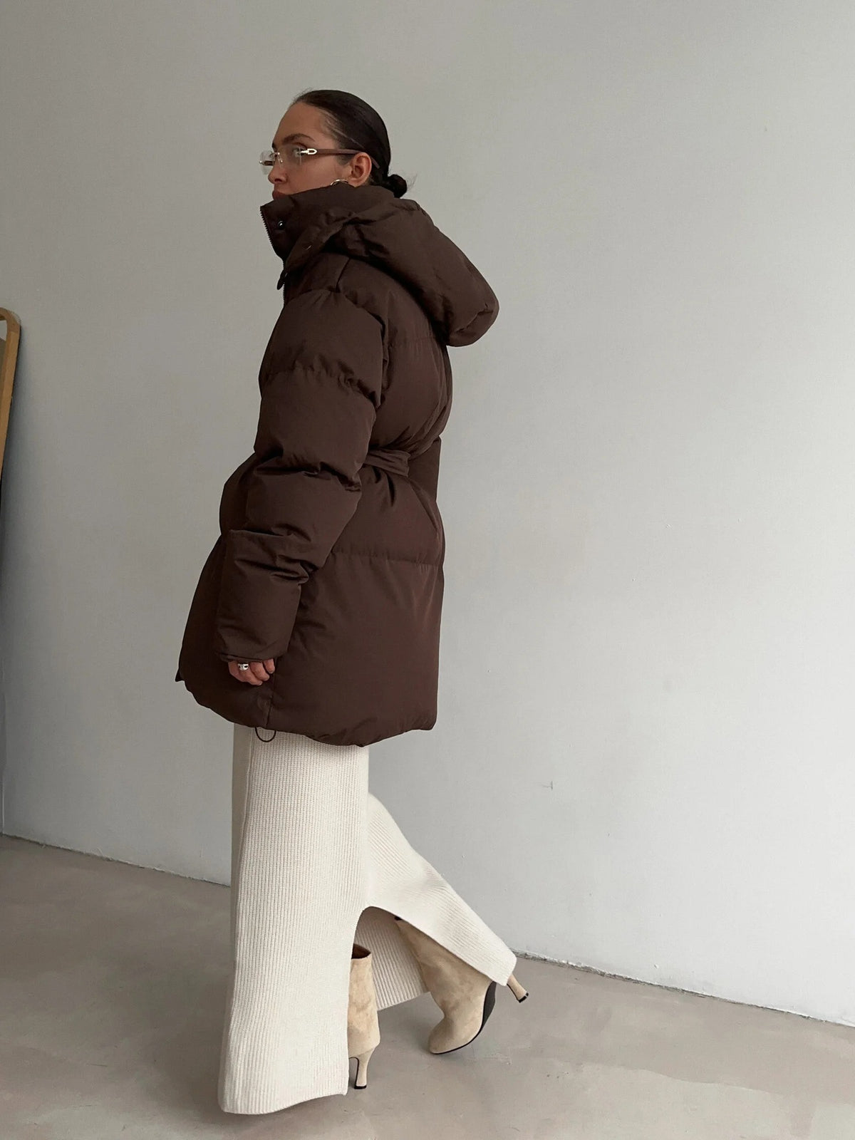 Belted Hooded Puffer Jacket with Zip Front in Espresso Brown — side view on model with the hood up