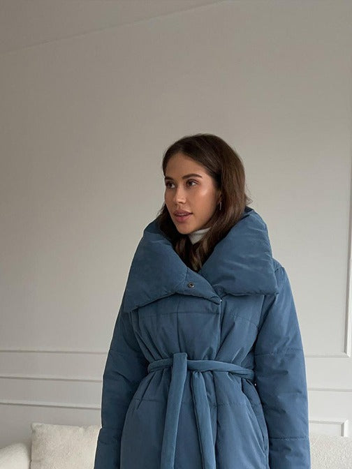 Long Belted Puffer Coat with Oversized Collar in Denim Blue — front view on model, belted