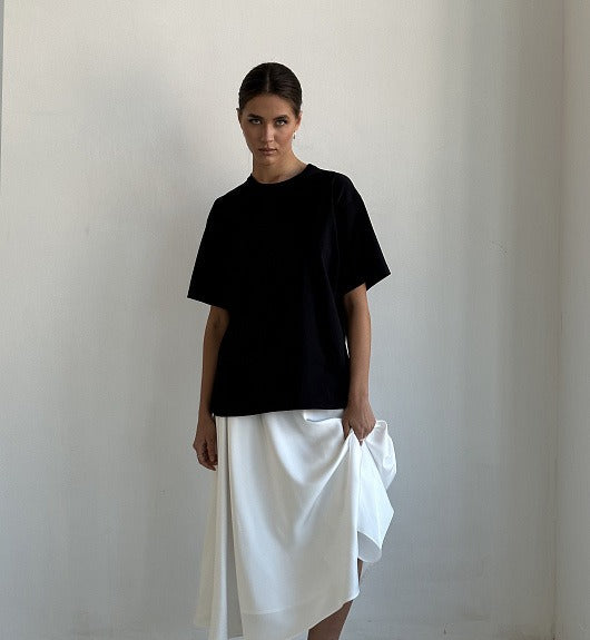 Satin A-Line Midi Skirt with Elastic Waist in Ivory White — on model with a black tee