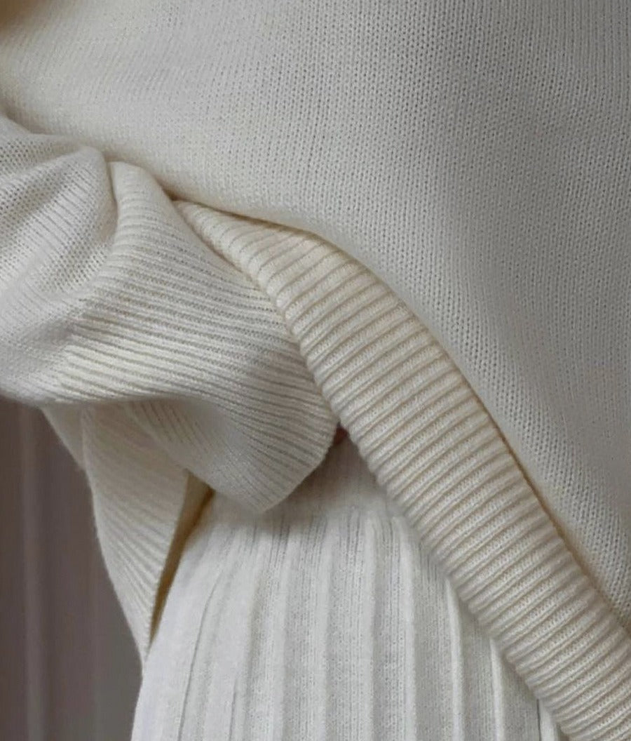 Oversized Crew Neck Sweater & Pleated Knit Mini Skirt Set in Ivory — close-up of the ribbed hem and pleats